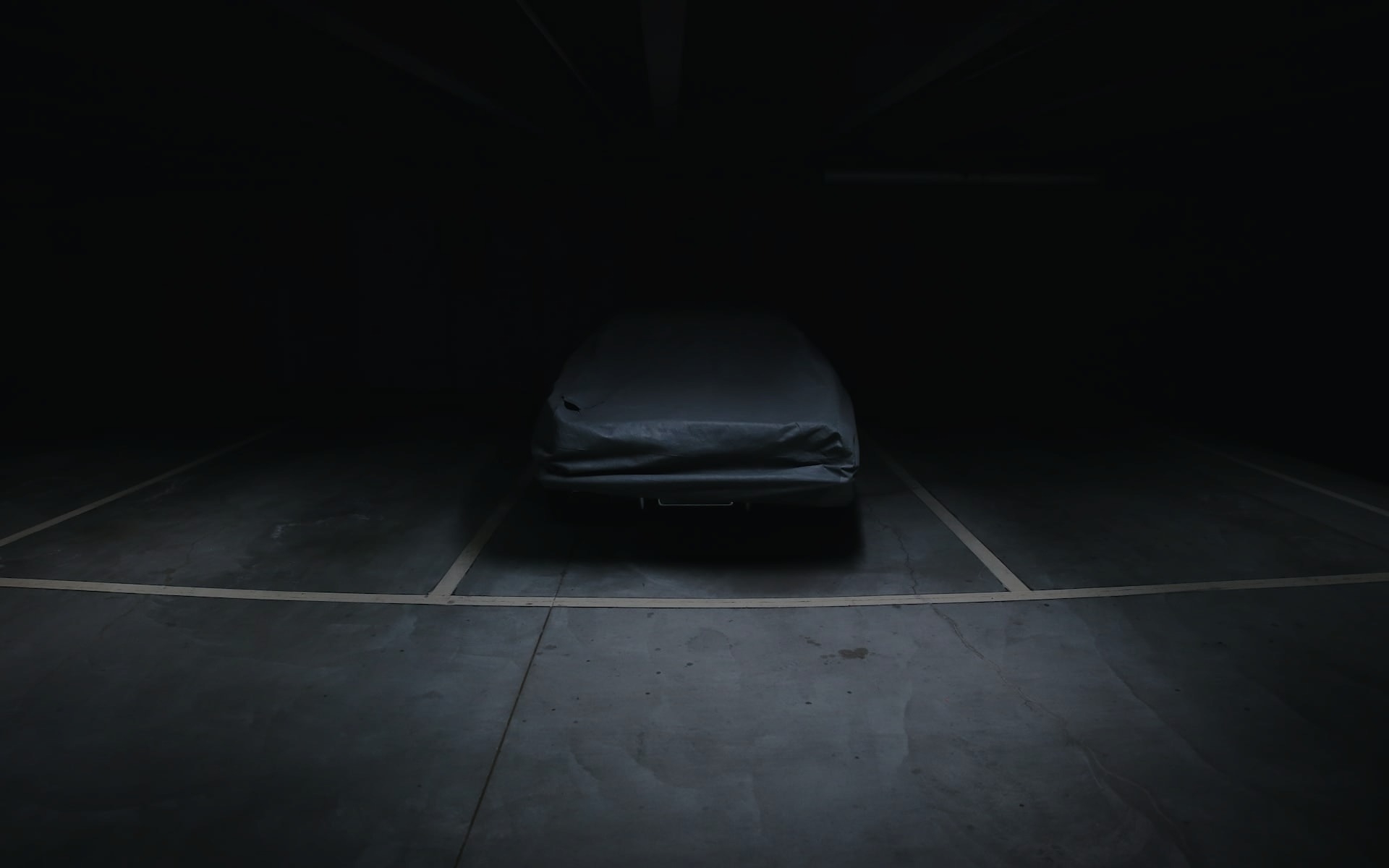 Car in garage covered with cover